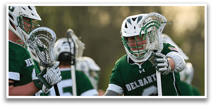 A man wearing a green jersey with the number 6 on it. Description generated by AI