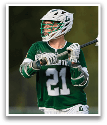 A man wearing a green and white jersey with the number 21 on it. Description generated by AI