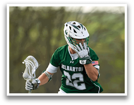 A man wearing a green and white jersey with the number 23 on it. Description generated by AI