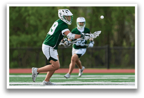 A man in a green and white uniform is running on a field. Description generated by AI