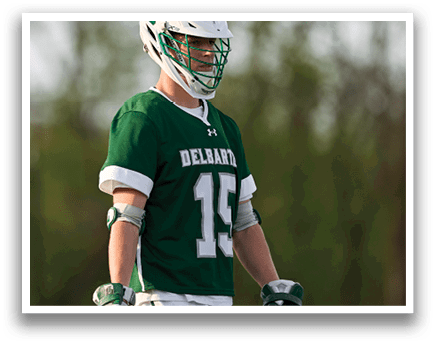 A man wearing a green and white jersey with the number 15 on it. Description generated by AI