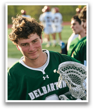 A man wearing a green jersey with the number 4 on it. Description generated by AI