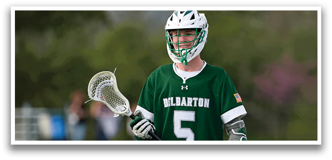 A man wearing a green and white jersey with the number 5 on it. Description generated by AI