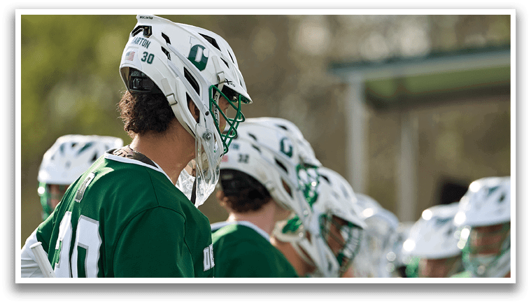 A group of people wearing green and white uniforms. Description generated by AI