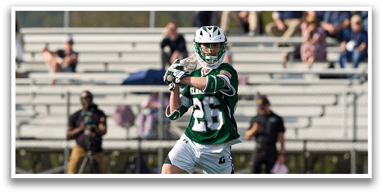 A man wearing a green and white shirt is running on a field. Description generated by AI