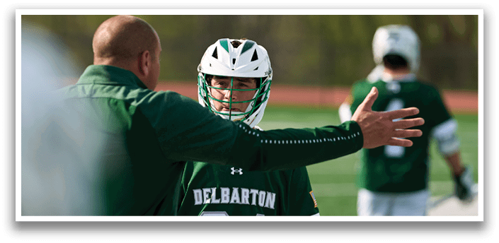 A man wearing a green and white uniform with the number 24 on the back. Description generated by AI
