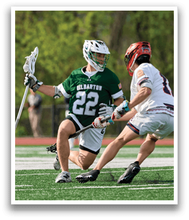 Two men playing lacrosse, one with the number 22 on his shirt. Description generated by AI