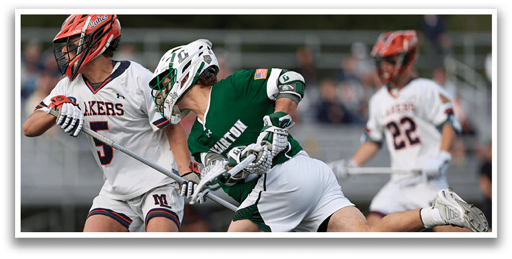 A man in a green shirt and white shorts is running with a hockey stick. Description generated by AI