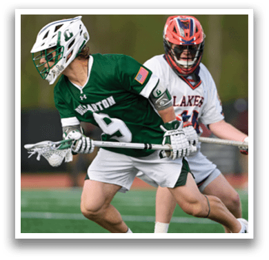 A man wearing a green and white jersey is running with a lacrosse stick. Description generated by AI