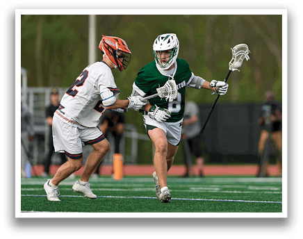 A man in a green jersey is running with a lacrosse stick. Description generated by AI
