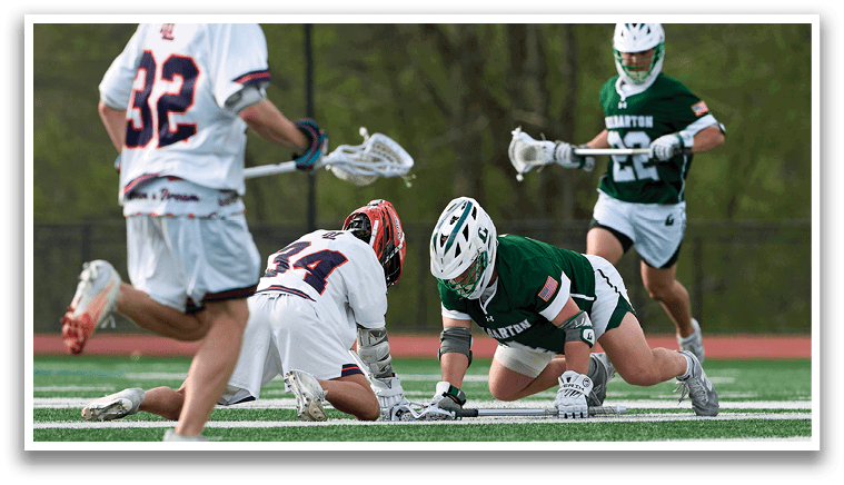 A group of people playing a game of lacrosse. Description generated by AI