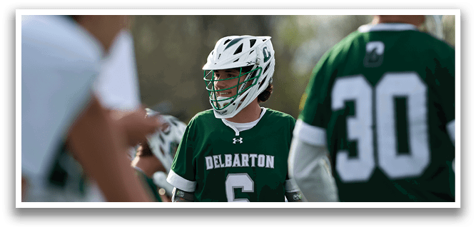 A boy wearing a green jersey with the number 6 on it. Description generated by AI