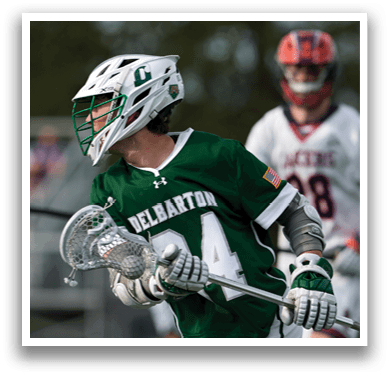 A man wearing a green and white jersey with the number 14 on it. Description generated by AI