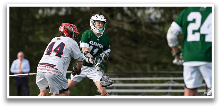 A man in a green and white uniform is playing baseball. Description generated by AI