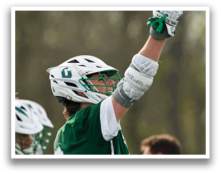 A man wearing a green and white shirt and holding his glove up in the air. Description generated by AI
