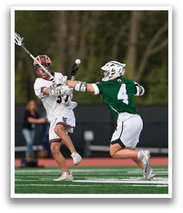 Two men playing lacrosse on a field. Description generated by AI