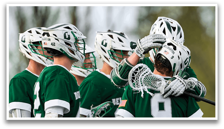 A group of lacrosse players wearing green and white uniforms. Description generated by AI