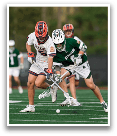 Two men playing hockey on a field. Description generated by AI