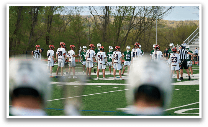 A group of people wearing green and white uniforms are standing on a field. Description generated by AI