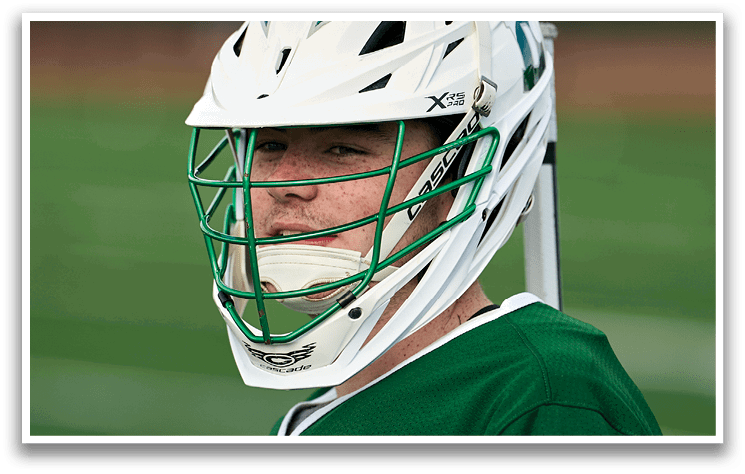 A man wearing a green and white jersey with the number 4 on it. Description generated by AI