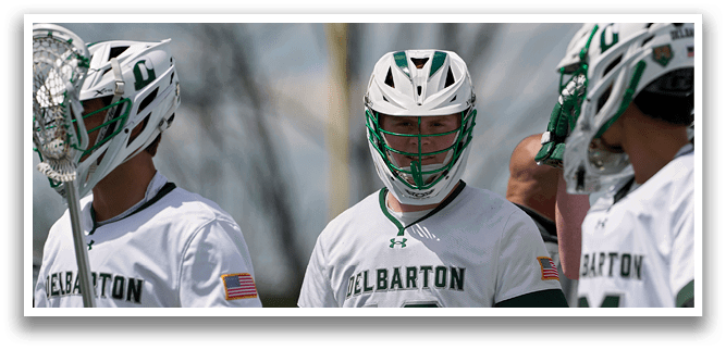 A group of lacrosse players wearing green and white uniforms. Description generated by AI