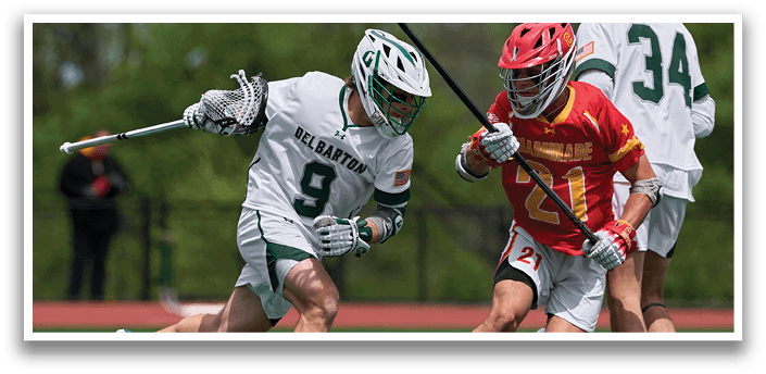 A man wearing a red helmet and white uniform is running on a field with a lacrosse stick. Description generated by AI