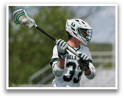 A man holding a lacrosse stick. Description generated by AI