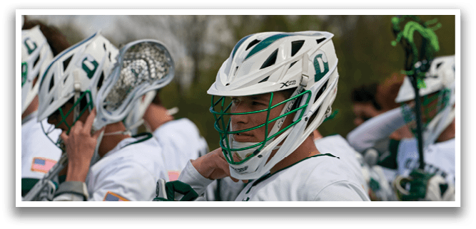 A man wearing a green and white helmet. Description generated by AI