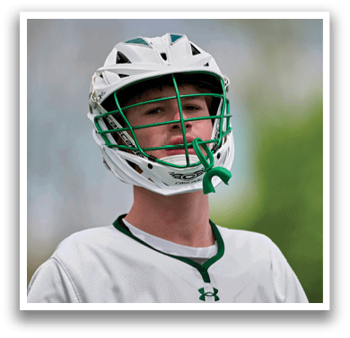 A man wearing a white and green helmet. Description generated by AI