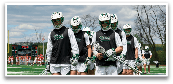 A group of lacrosse players walking on a field. Description generated by AI