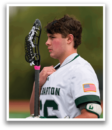A man holding a lacrosse stick. Description generated by AI