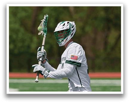 A man holding a lacrosse stick. Description generated by AI