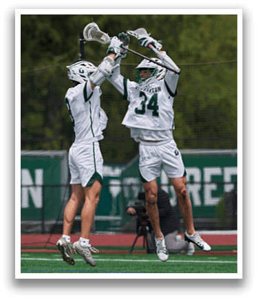 Two men are jumping in the air on a field. Description generated by AI