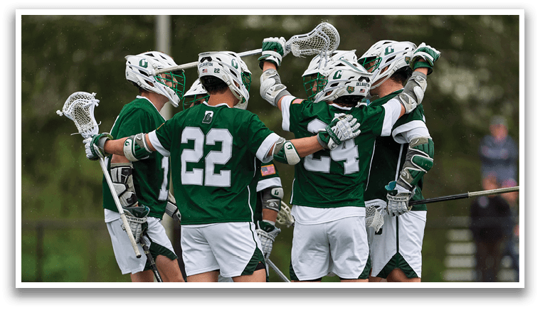 A group of men wearing green and white uniforms are hugging each other. Description generated by AI