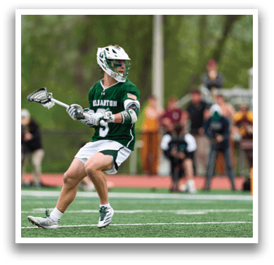 A man wearing a green and white uniform is running on a field. Description generated by AI