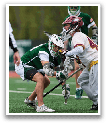 Two men playing hockey on a field. Description generated by AI