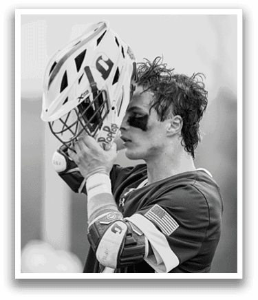 A man wearing a helmet with the number 20 on it. Description generated by AI