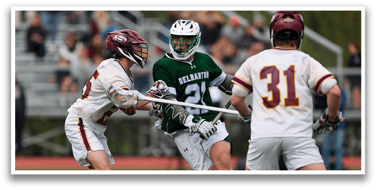 A group of men playing a game of lacrosse. Description generated by AI