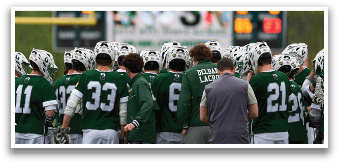 A group of people wearing green jerseys. Description generated by AI
