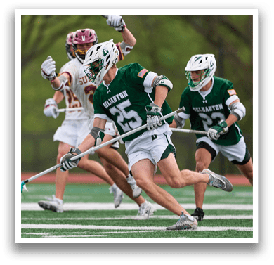 A boy wearing a green jersey with the number 2 on it. Description generated by AI