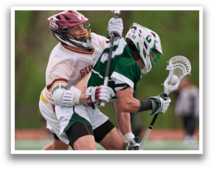 Two men playing lacrosse. Description generated by AI