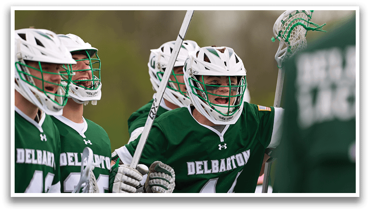 A group of people wearing green and white uniforms. Description generated by AI