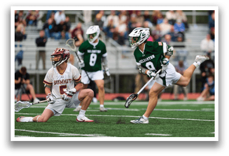 A man in a green jersey is running with a stick. Description generated by AI