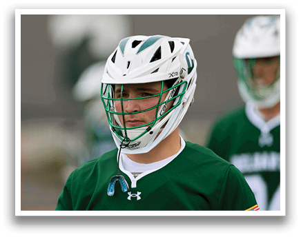 A man wearing a green and white helmet. Description generated by AI