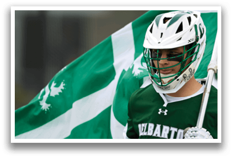 A man wearing a green and white jersey with the number 8 on it. Description generated by AI