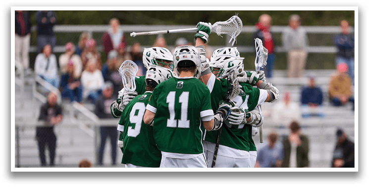 A group of lacrosse players hugging each other. Description generated by AI