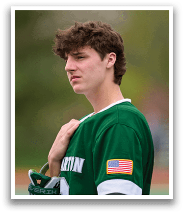 A man wearing a green and white jersey with an American flag patch. Description generated by AI