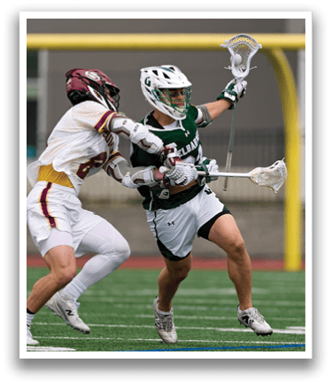 Two men playing lacrosse on a field. Description generated by AI