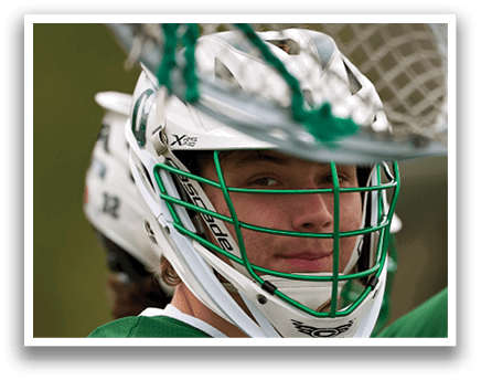 A man wearing a green and white helmet. Description generated by AI