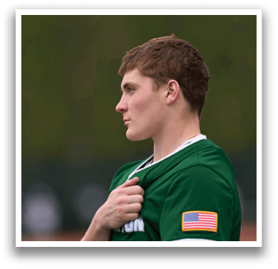 A man wearing a green and white shirt with the number 7 on it. Description generated by AI
